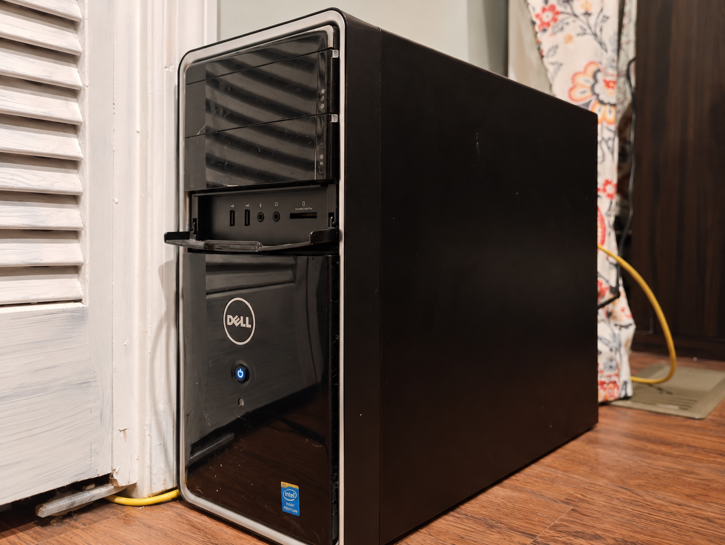 Older black Dell Inspiron desktop tower with silver trim, repurposed as a home Linux server.
